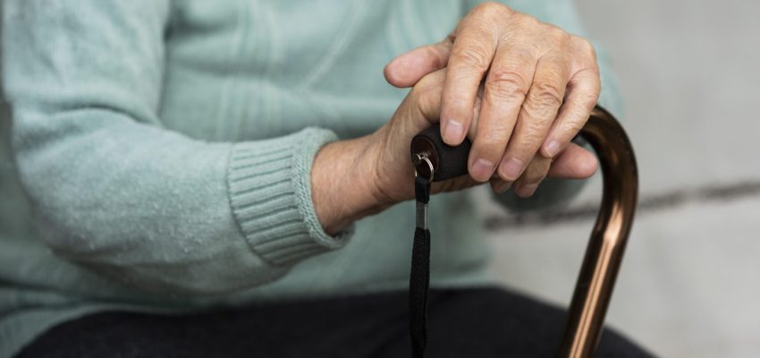 elder-woman-holding-cane-in-her-hands